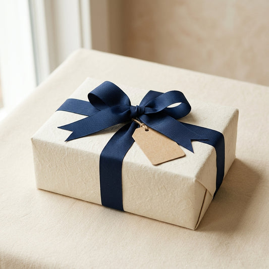 Gift wrapping - cream paper with navy ribbon